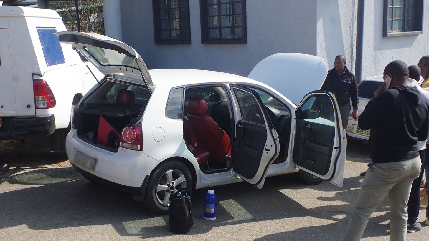 Police officers searching the VW Golf which was used by a Botswana national and liSwati when they came to court to check on the accused who were arrested for illegal possession of explosive NONEL tubing.